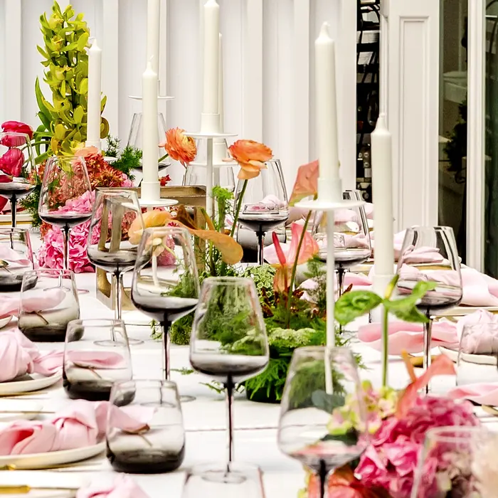 Long table styled with flowers and glassware by Taylor Morgan Creative